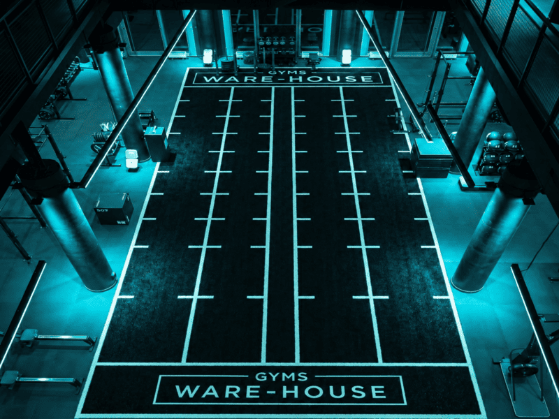Heavy tire drag training on high-density gym turf